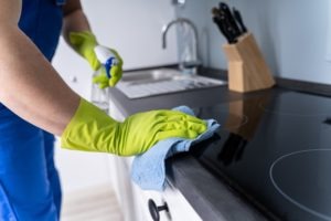 house cleaner wiping kitchen top